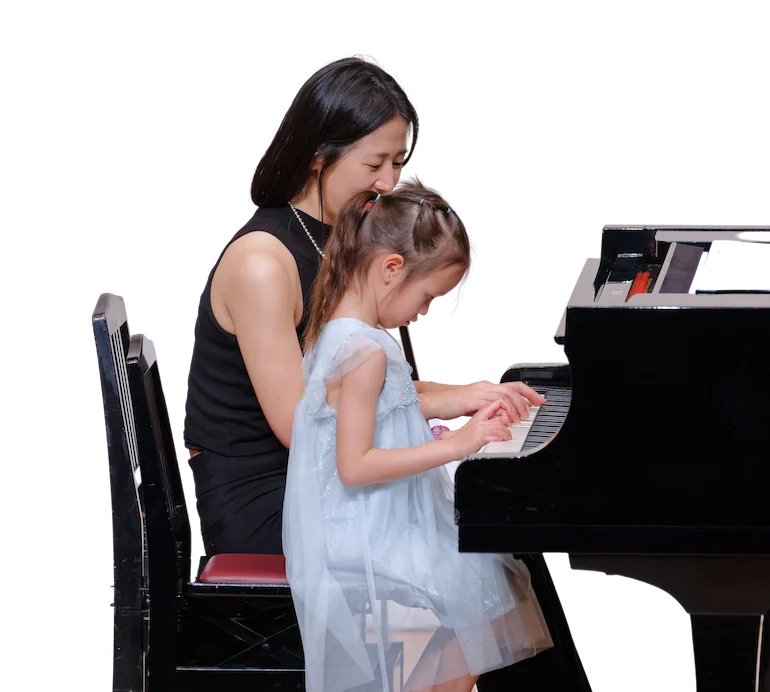 girl taking piano lesson